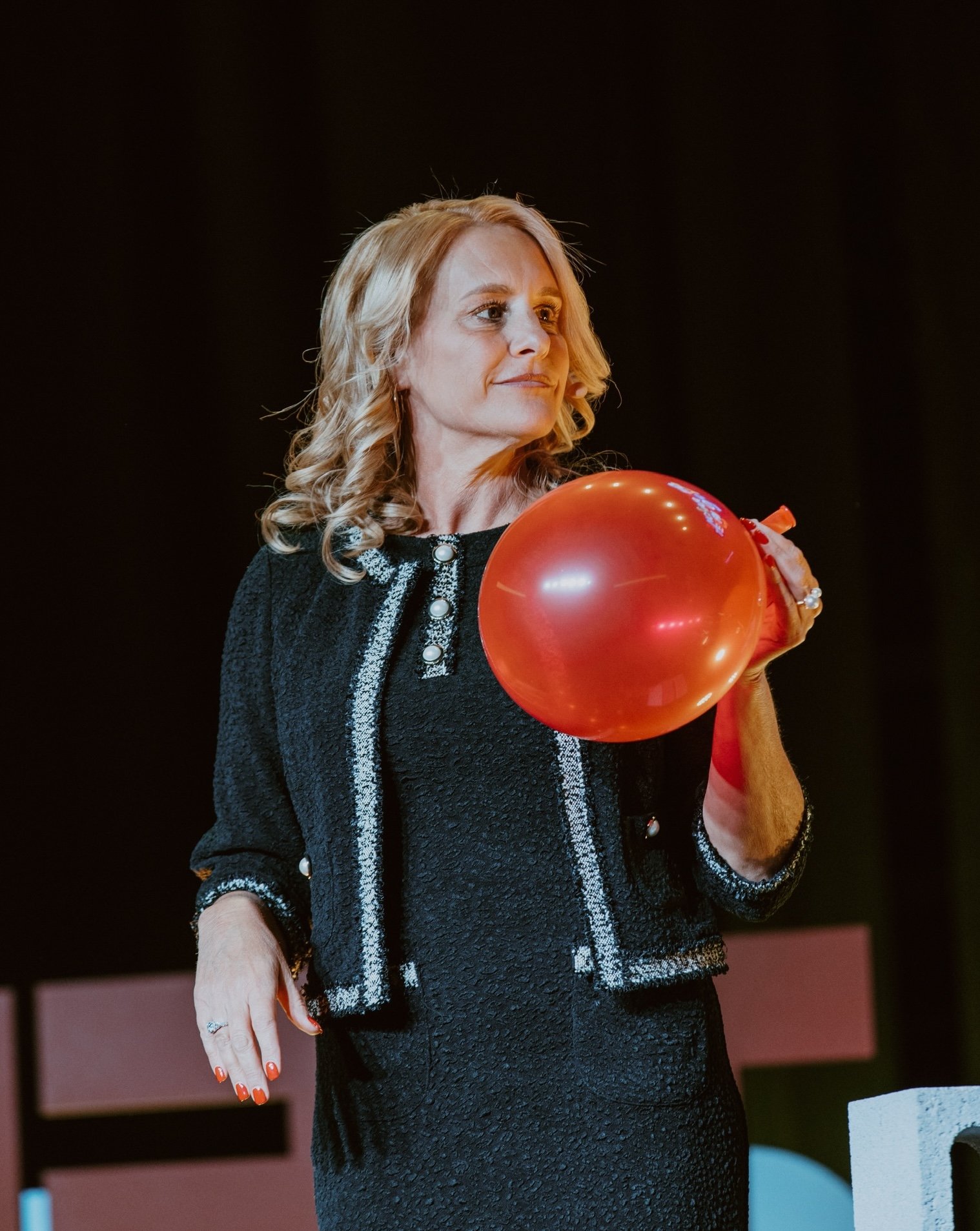 Jennifer Edwards holding a balloon on stage